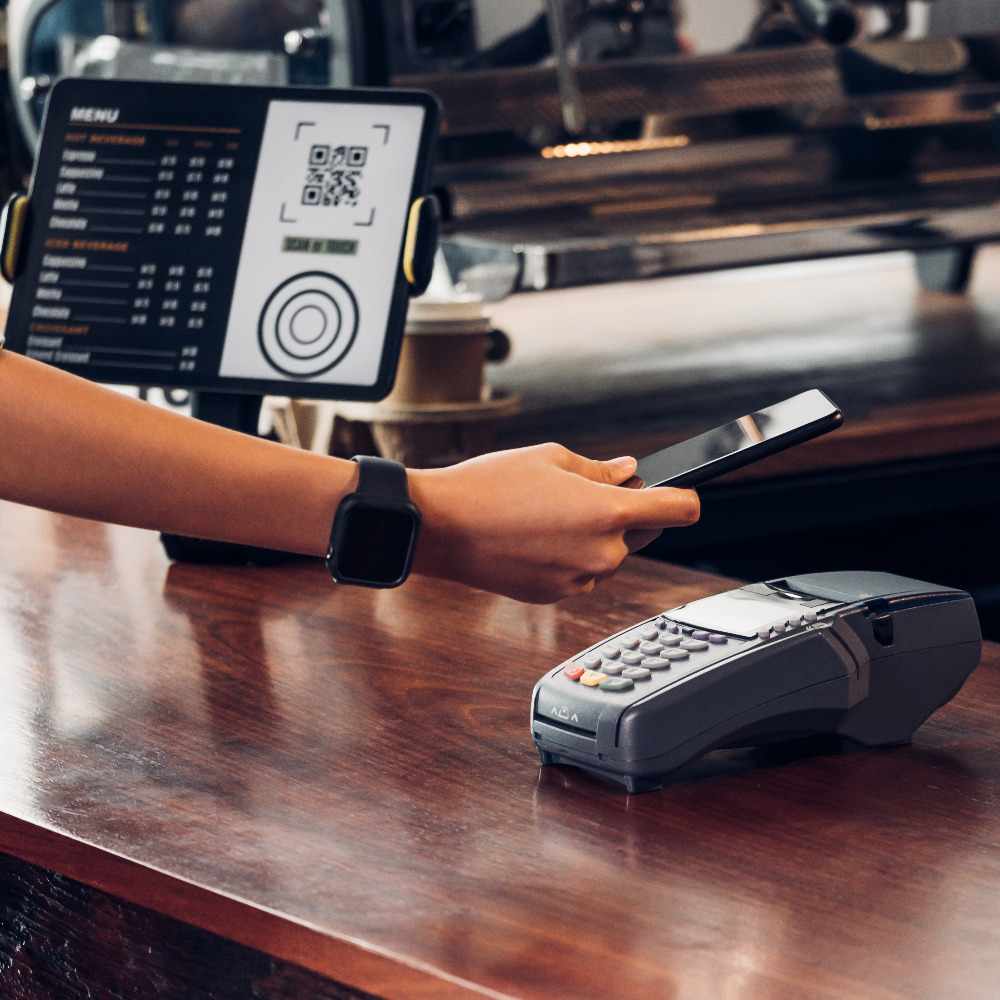 customer contactless payment for drink with mobile phone at cafe counter bar,seller coffee shop accept payment by mobile.new normal lifestyle concept
